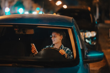 Lost female driver using mobile phone while driving at night.