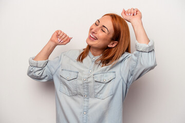 Young caucasian woman isolated on white background celebrating a special day, jumps and raise arms with energy.