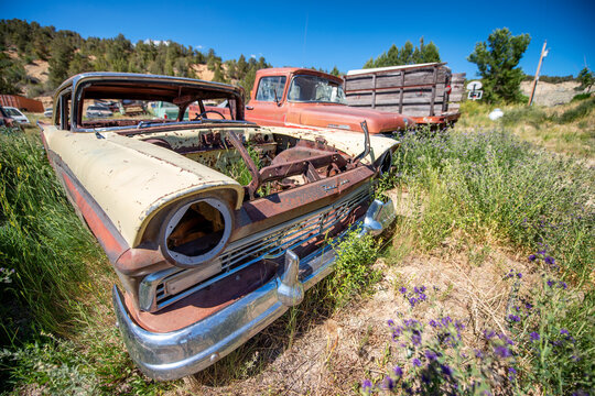 GLENSDALE, UT - JUNE 20, 2018: Rusty old cars under a blue summer sky..