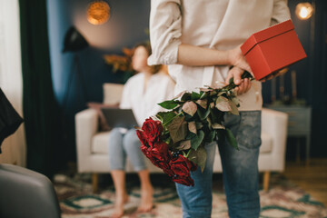 Young man giving present to his girlfriend. Valentine's Day celebration.