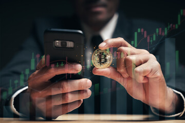 Businessman holding golden bitcoin on computer trading chart screen background. stock, cryptocurrency trading Concept....