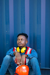 Fototapeta premium Time for a break concept. African American Industrial, factory and energy engineer Specialist sitting on floor at workplace.