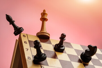The black chess pieces attack the white queen on the edge of the chessboard. Concept of competitive...