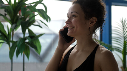 Attractive woman in spa center talking on the phone