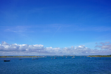 Small boats floating in blue ocean 