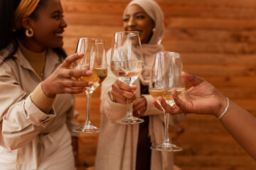 Carefree friends toasting with drinking glasses in a cafe