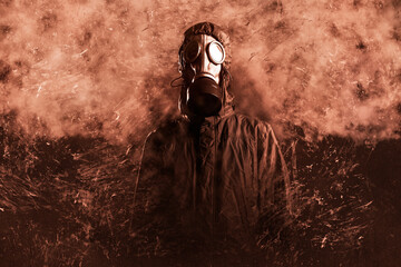 proud male stalker. He is dressed in a protective jacket with a hood, a gas mask. He looks into the...