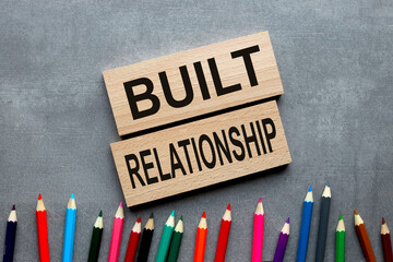 built relationship two wooden blocks on a gray background, seminar conference center.trip. business concept