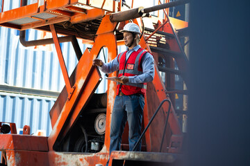 Marine and carrier insurance concept. Cargo container yard. Portrait caucasian man engineer worker wearing hardhat safety helmet and vest working in  logistic shipping yard.