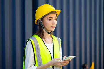 Portrait of Women worker control loading Containers box from Cargo at container yard. Import and Export concept. Marine, carrier and logistic insurance