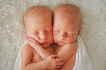 Twins. The large family. Brothers. Newborn babies. Boys. Newborn twins together. Love. Happy family. Sweet babies. Twins. Newborn babies are fast asleep. Newborn twins hugging each other. Newborn port