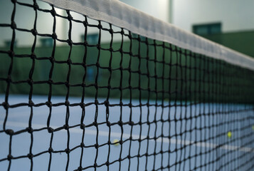 Empty blue tennis court. Tennis net and ball.
