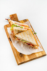 Sandwich with ham, cheese, tomatoes, lettuce, and toasted bread