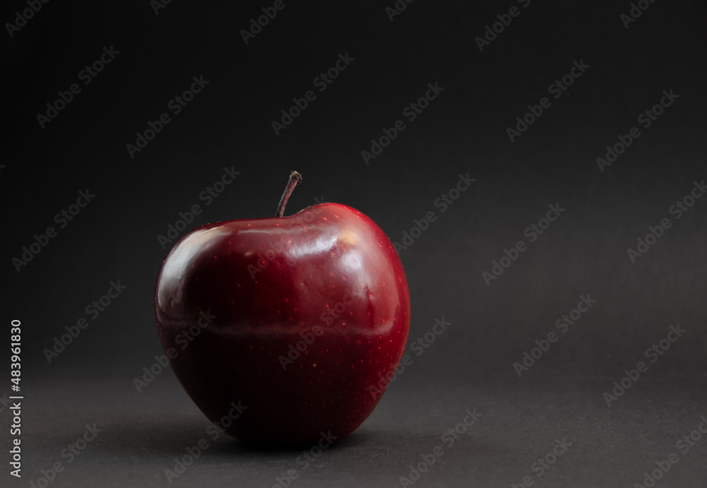 Wall mural Red apple on a black background. - Wall murals