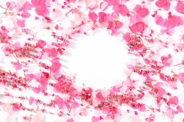 Valentine day background with paper pink hearts and rose flowers confetti, a flat lay on a white background with a place for text, a frame for a greeting card or invitation