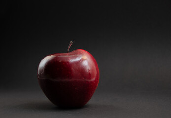 Red apple on a black background.