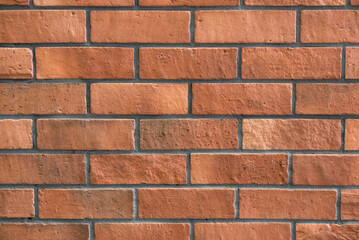 Reddish brown brick wall background.