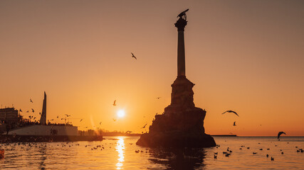 Monument to sunken ships in Black sea water on sunset. Sevastopol, Crimea