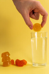 Dissolvable drinks dissolving cubes to add superfoods. On a yellow background. Vertical photo