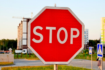 Stop road sign on the background of building a house