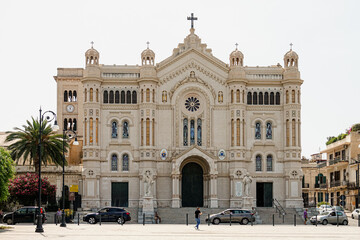 Obraz premium The cathedral in the historic city centre, where it shows its main façade on the wide Piazza. Reggio Calabria, Italy - July 2021