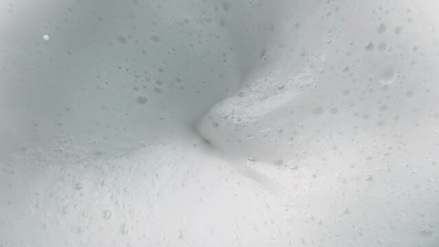top of view of super slow motion shot of fresh cream white milk vortex, concept of nutrition and health