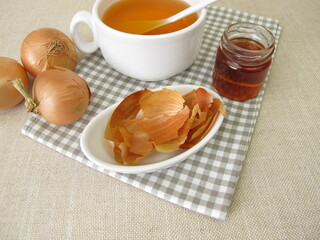 A cup of onion peel tea with honey