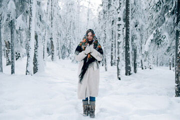 Russian beautiful girl in winter forest