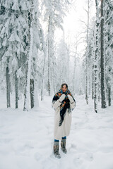 Fototapeta na wymiar Russian beautiful girl in winter forest