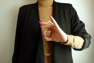 Businesswoman making okay sign, client satisfaction, positive customer experience concept