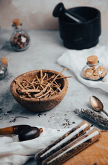 herbalist table with dried herbs, flowers and mortar