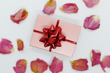 Box with a gift in rose petals