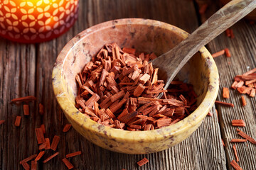 Red sandalwood in a stone bowl
