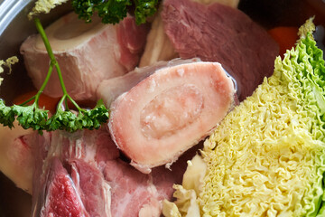 Marrow bones, vegetables and beef meat - preparation of homemade bone broth