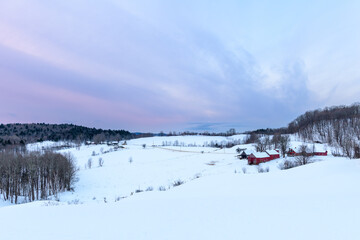 Photograph of a farm during a winter sunrise
