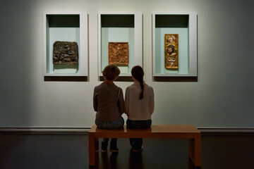 visitor looking pictures in art gallery