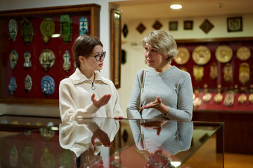 family looking at expositions of previous centuries in museum