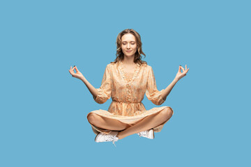 Hovering in air. Calm peaceful relaxed girl ruffle dress levitating with mudra gesture hands up,...