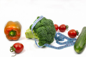 Fresh broccoli, cucumber, pepper and tomatoes on white background