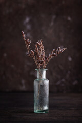 Lavender in galss vase on wooden table. Lavender or lilac dried bouquet.