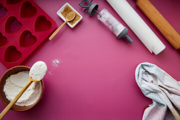 Preparing for baking: heart-shaped silicone mold, rolling pin, confectionery syringe, glaze, flour, sugar. Valentine's day concept. Copy space. High quality photo