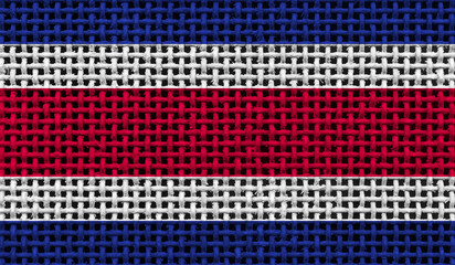 Costa Rica flag on the surface of a metal lattice. 3D image