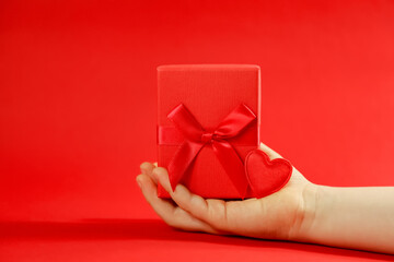 hand holding gift, hand with heart, happy valentine's day