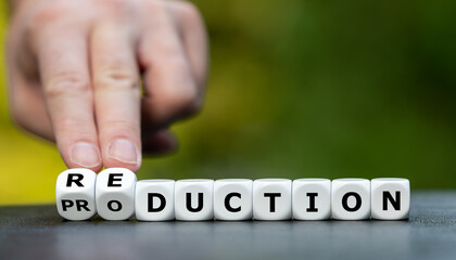 Hand turns dice and changes the word production to reduction.
