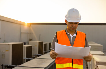 Smart civil engineer, inspectors are holding clipboard and drawing looking and working outdoors...
