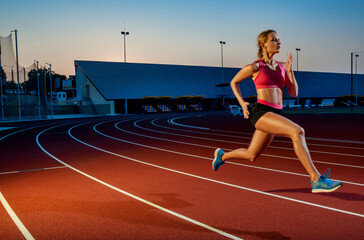Fototapeta premium Runner sprinting towards success on run path running athletic track. Goal achievement concept.