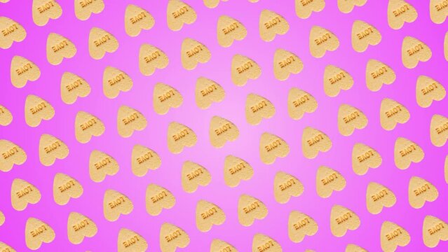 This stock motion graphics video shows a moving pattern background of Valentines heart-shaped yellow candies with label "Love". 3 in 1 animation: a different sides and size Rotating Background is a te