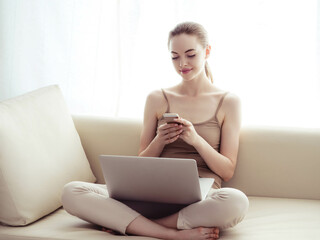 Fototapeta na wymiar Woman with laptop on sofa working home alone lifestyle.