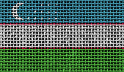 Uzbekistan flag on the surface of a metal lattice. 3D image