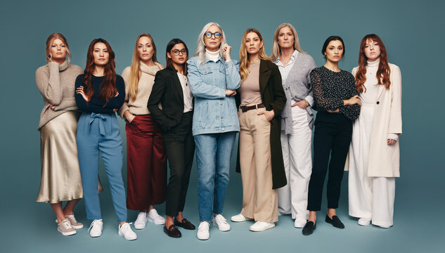 Nine empowered women standing together in a studio